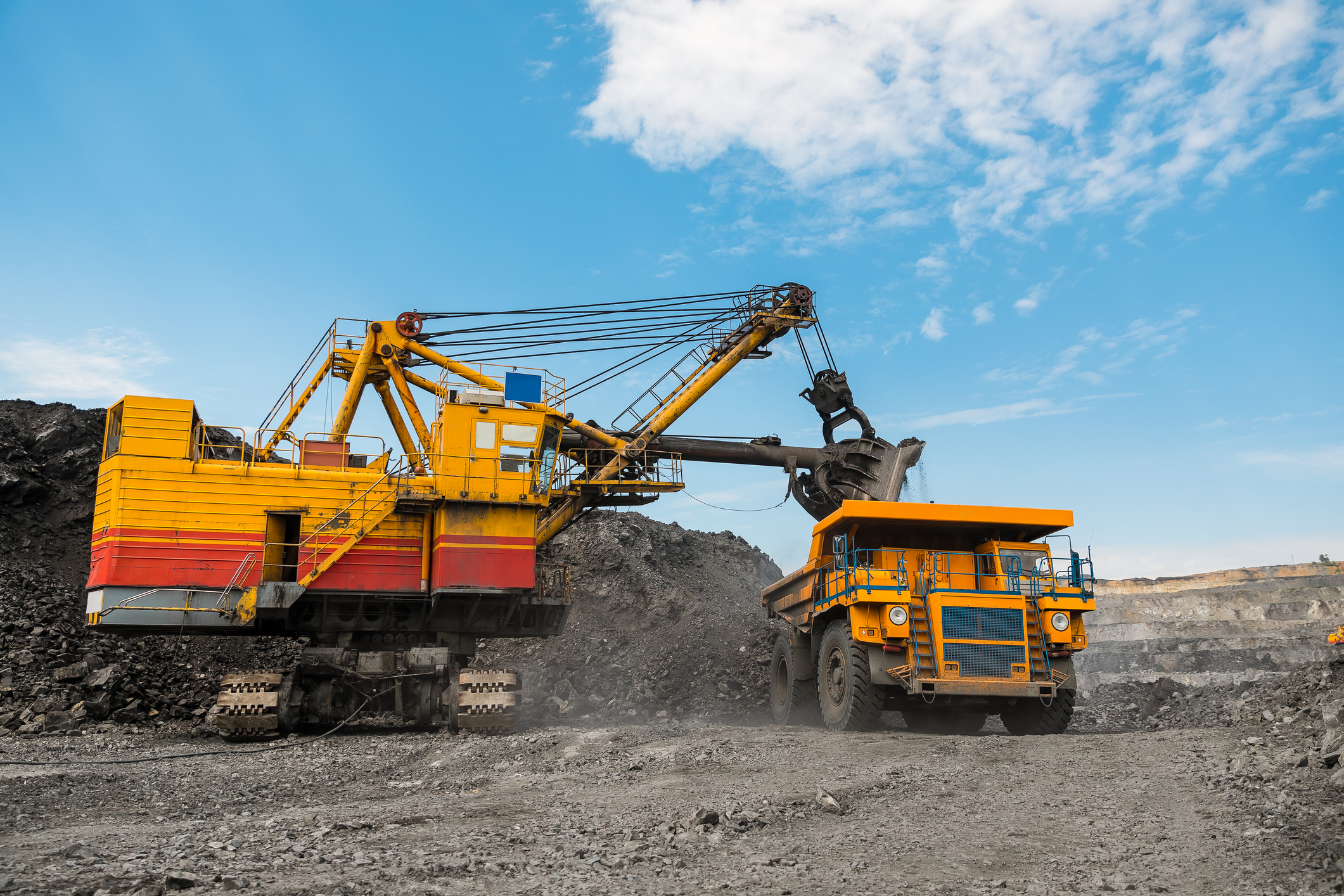Large Quarry Dump Truck. Loading The Rock In Dumper. Loading Coal Into Body Truck. Production Useful Minerals. Mining Truck Mining Machinery, To Transport Coal From Open Pit As The Coal Production.