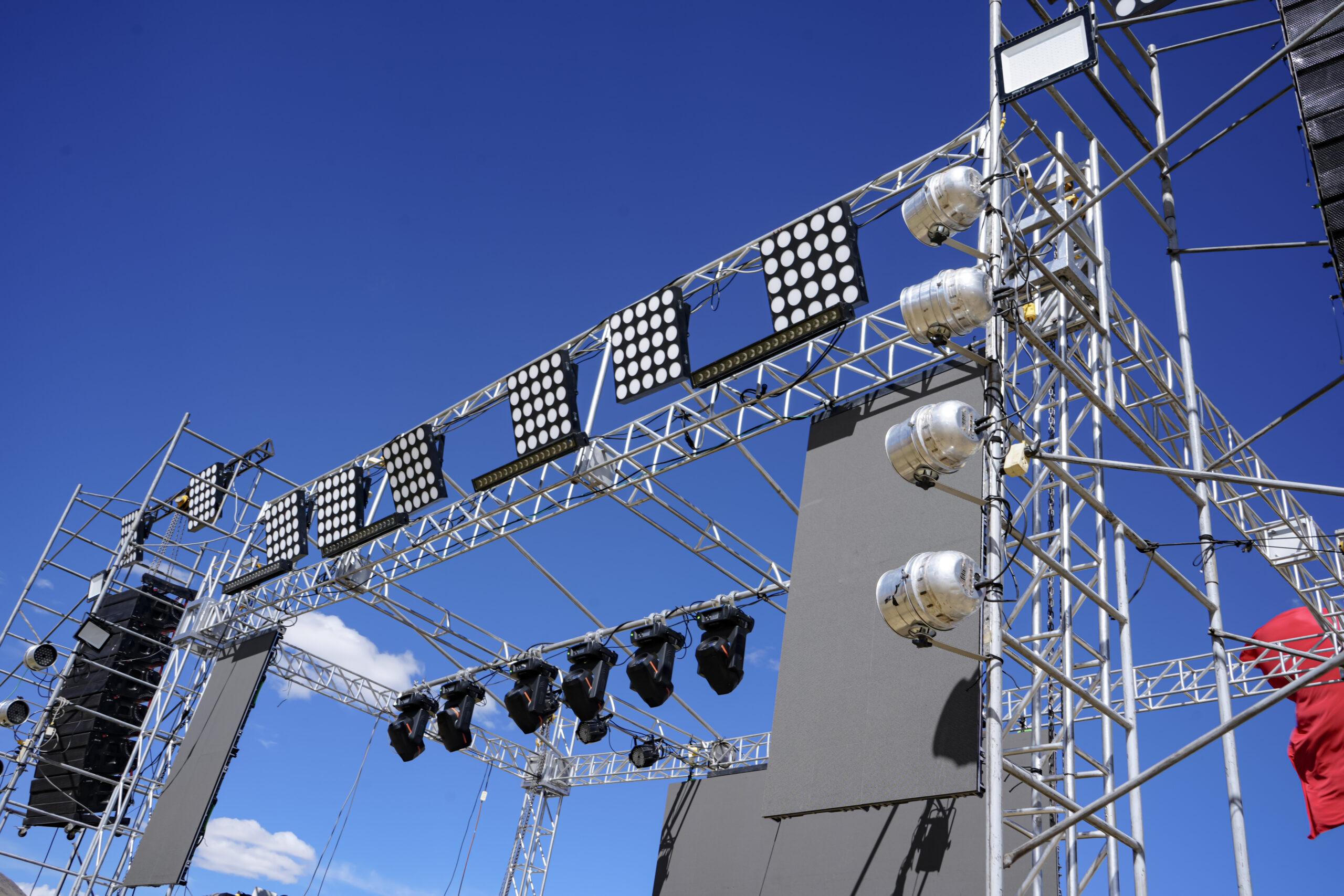 Outdoor Stage Lighting Rig With Par Lamps And Led Matrices Under Blue Sky